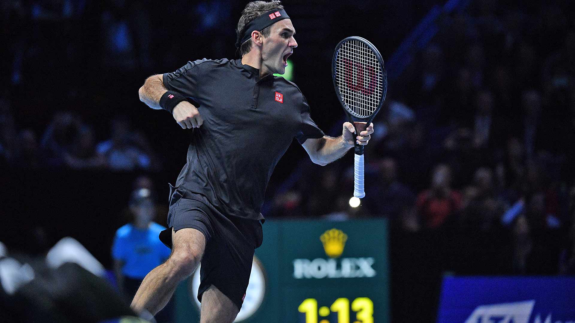 Roger Federer leaps for joy after beating Novak Djokovic to reach the Nitto ATP Finals semi-finals.