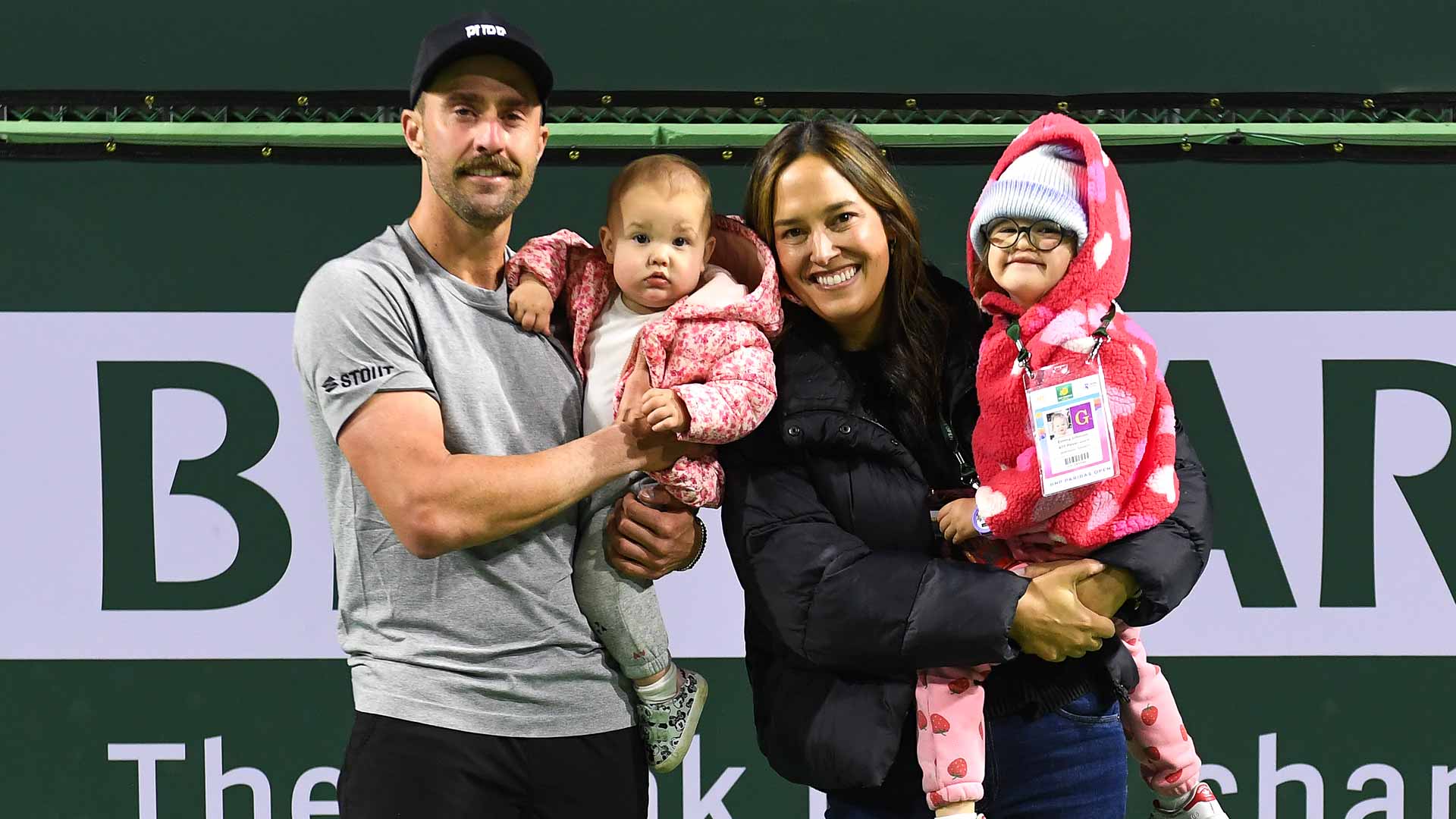 Steve Johnson poses for a photo with his wife Kendall and daughters, Molly and Emma, after his final singles match.