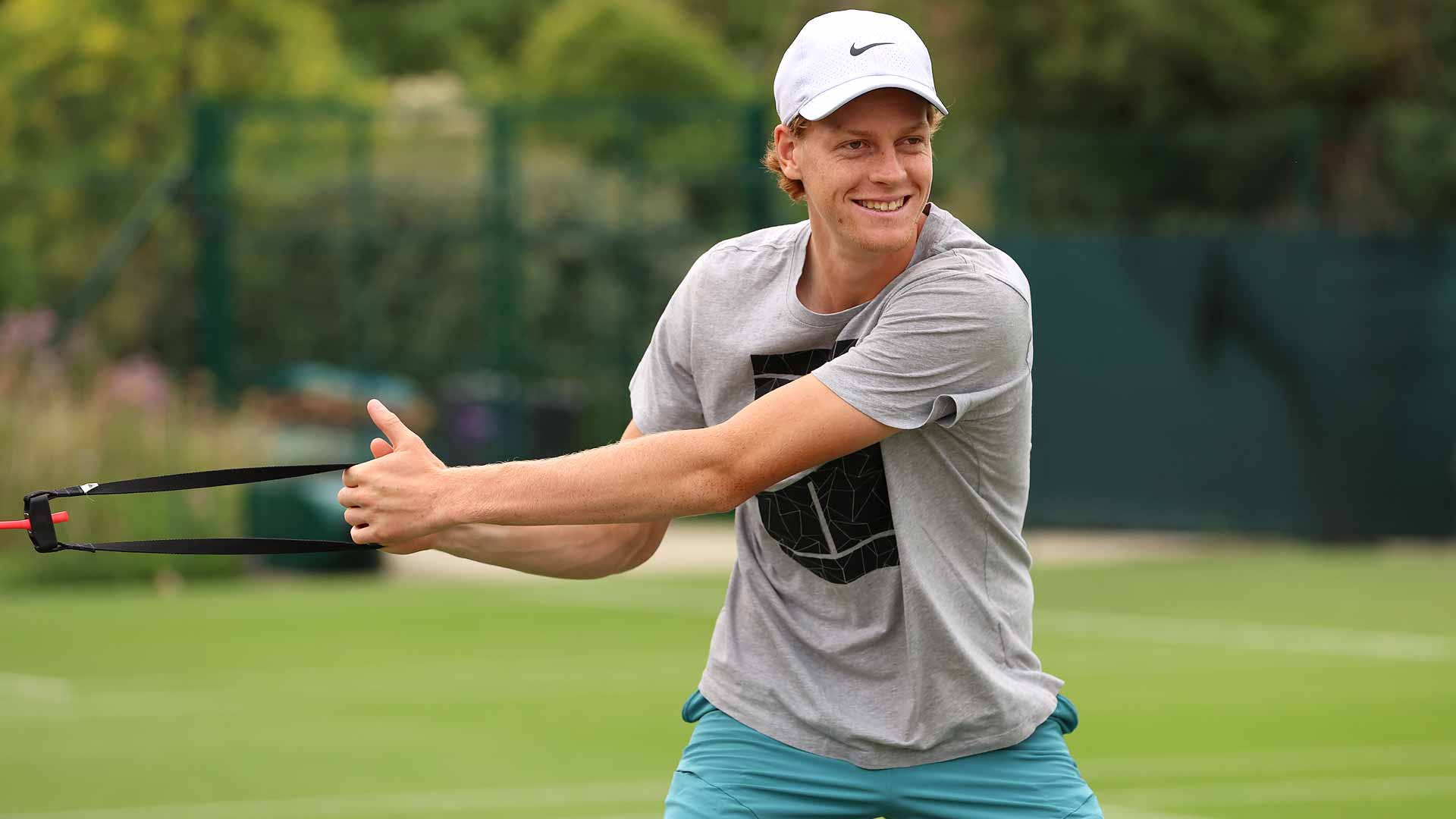 Jannik Sinner stretches at practice on Tuesday ahead of Wimbledon.