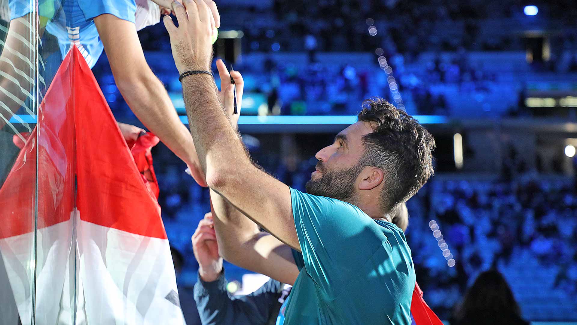 Horia Tecau signs autographs on Thursday after his final ATP Tour match.