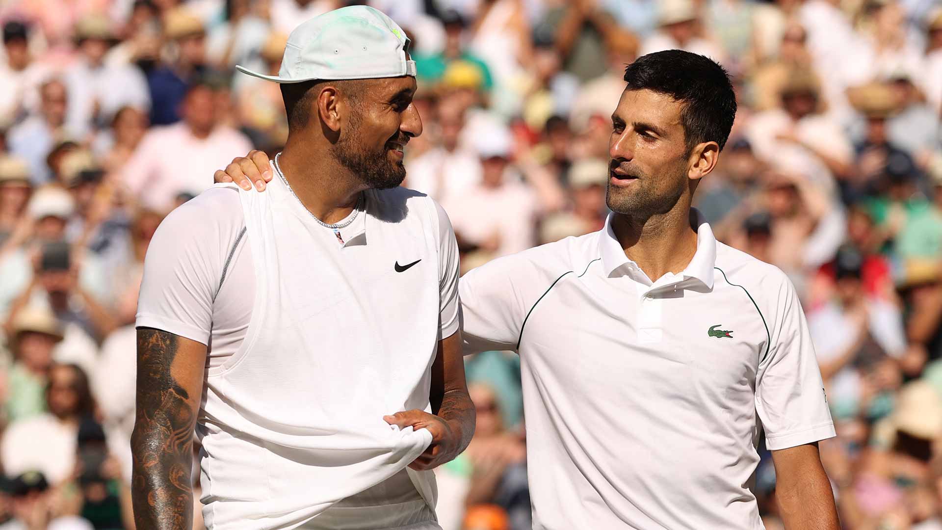 Nick Kyrgios and Novak Djokovic embrace following the 2022 Wimbledon final.