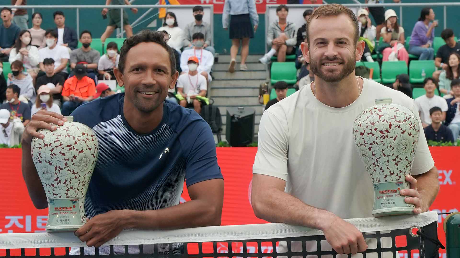 Raven Klaasen and Nathaniel Lammons celebrate their maiden ATP Tour title as a team on Sunday at the Eugene Korea Open Tennis Championships in Seoul.