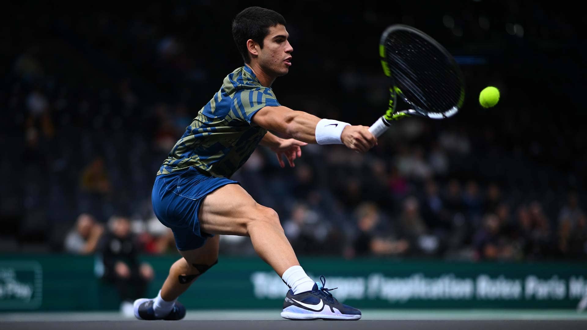Carlos Alcaraz retrieves a ball against Grigor Dimitrov on Thursday at the Rolex Paris Masters.