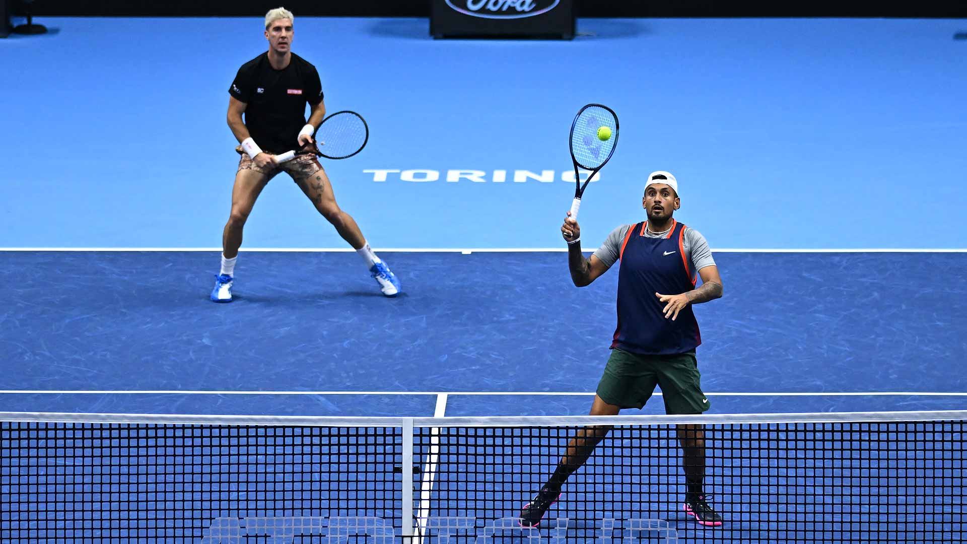 Thanasi Kokkinakis and Nick Kyrgios in action on Wednesday at the Pala Alpitour in Turin.