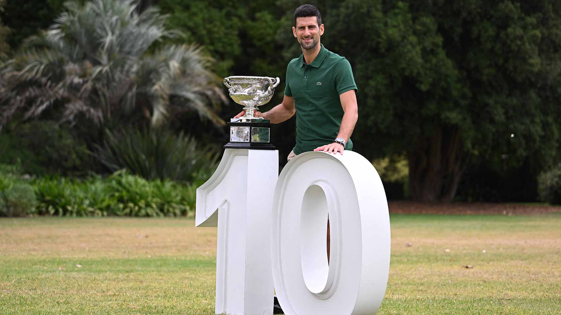 Novak Djokovic poses with the Norman Brookes Challenge Cup on Monday in the gardens of Melbourne's Government House.