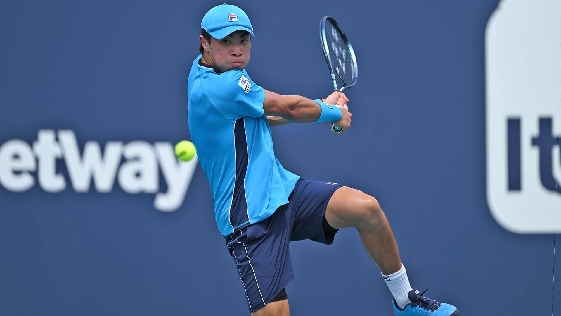 Brandon Nakashima jumps into a backhand en route to defeating Oscar Otte on Wednesday at the Miami Open presented by Itau.