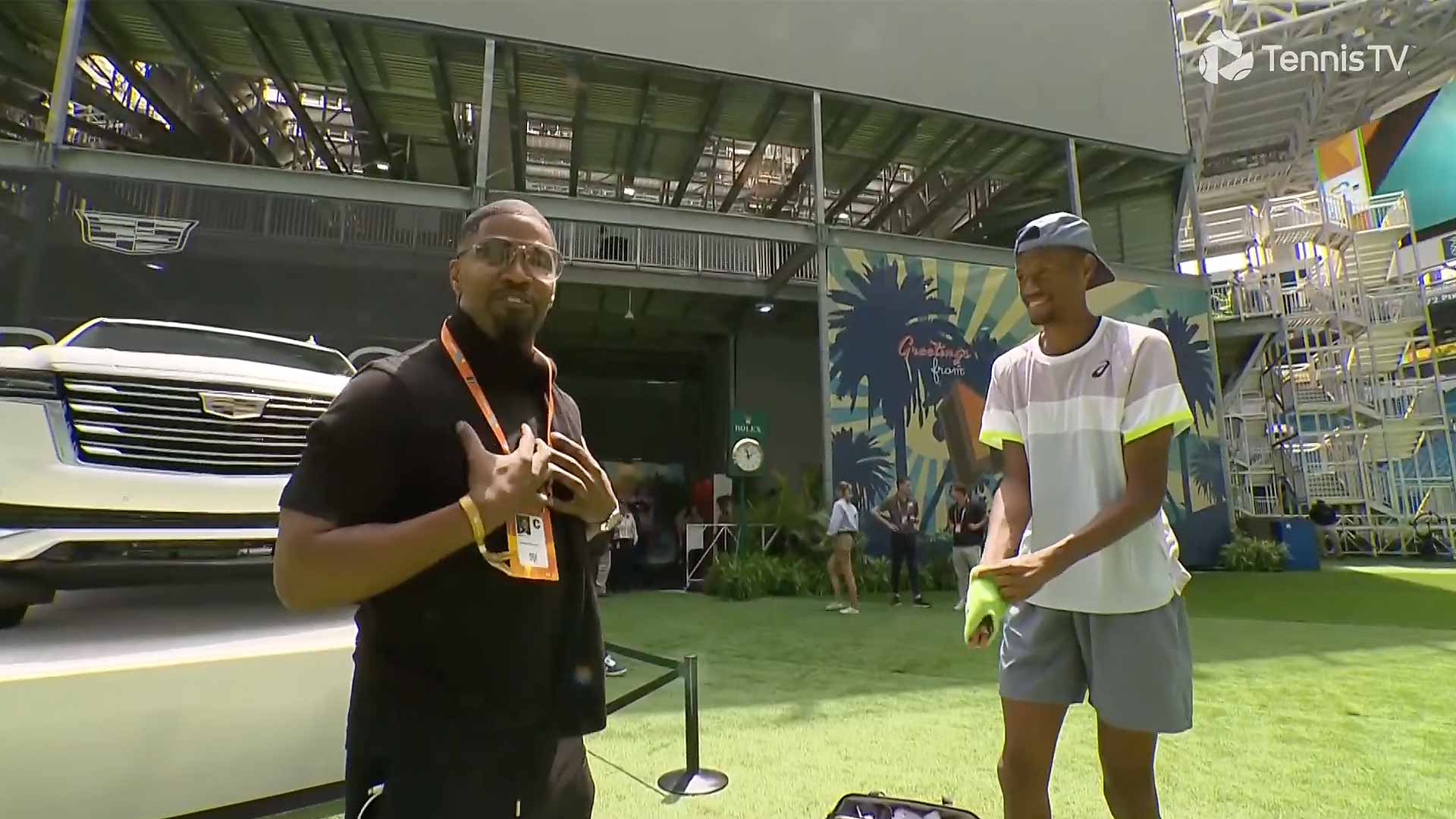 Jamie Foxx meets with Chris Eubanks during the rain delay on Thursday.