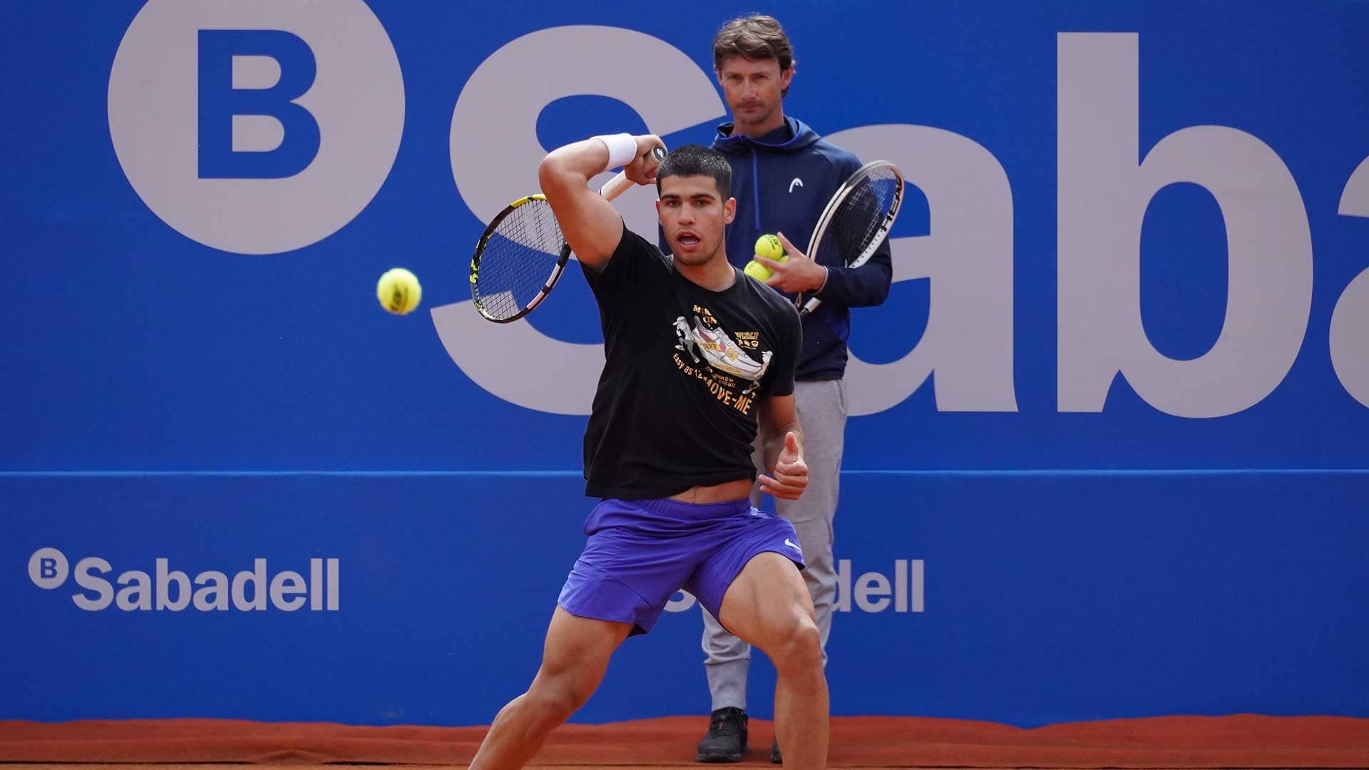 Carlos Alcaraz practises in front of his coach Juan Carlos Ferrero at the Barcelona Open Banc Sabadell.