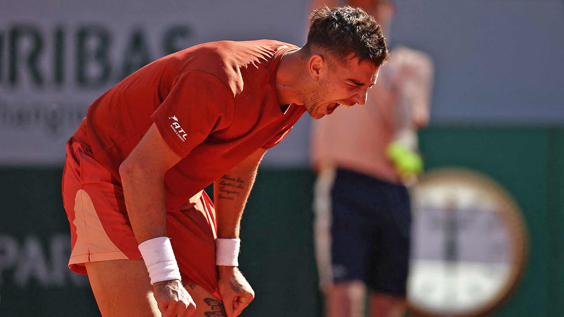 Thanasi Kokkinakis roars in celebration after defeating Stan Wawrinka on Wednesday at Roland Garros.