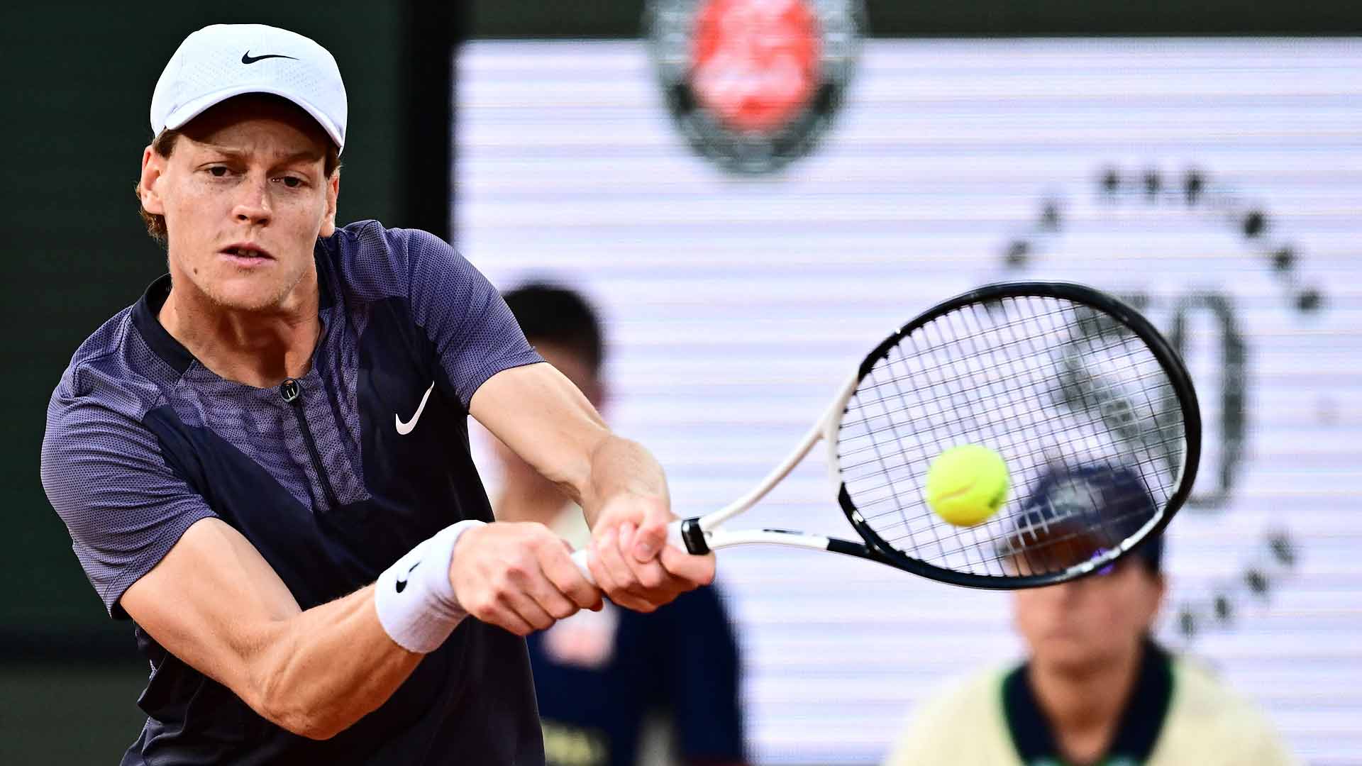 Jannik Sinner powers a backhand during his first-round match against Alexandre Muller on Tuesday at Roland Garros.