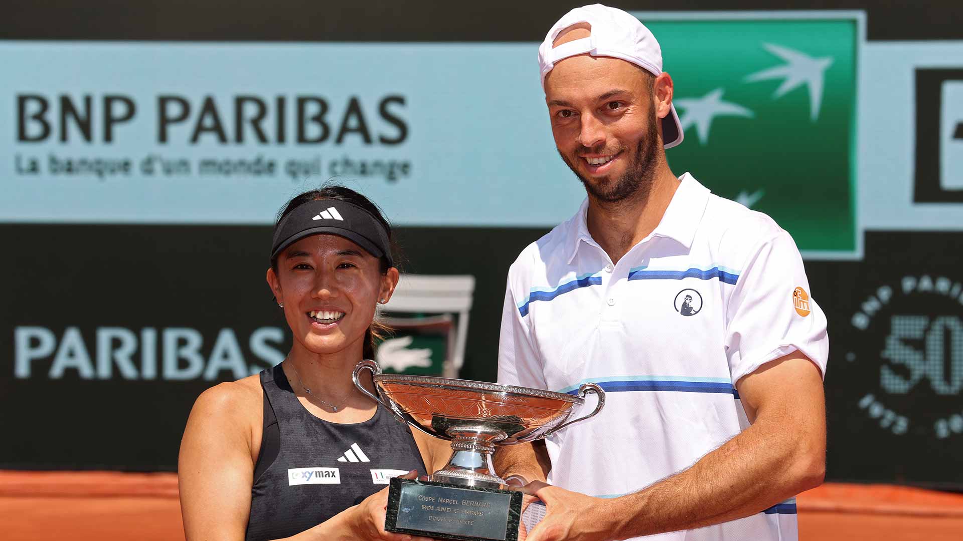 Miyu Kato and Tim Puetz lift the trophy in Paris.