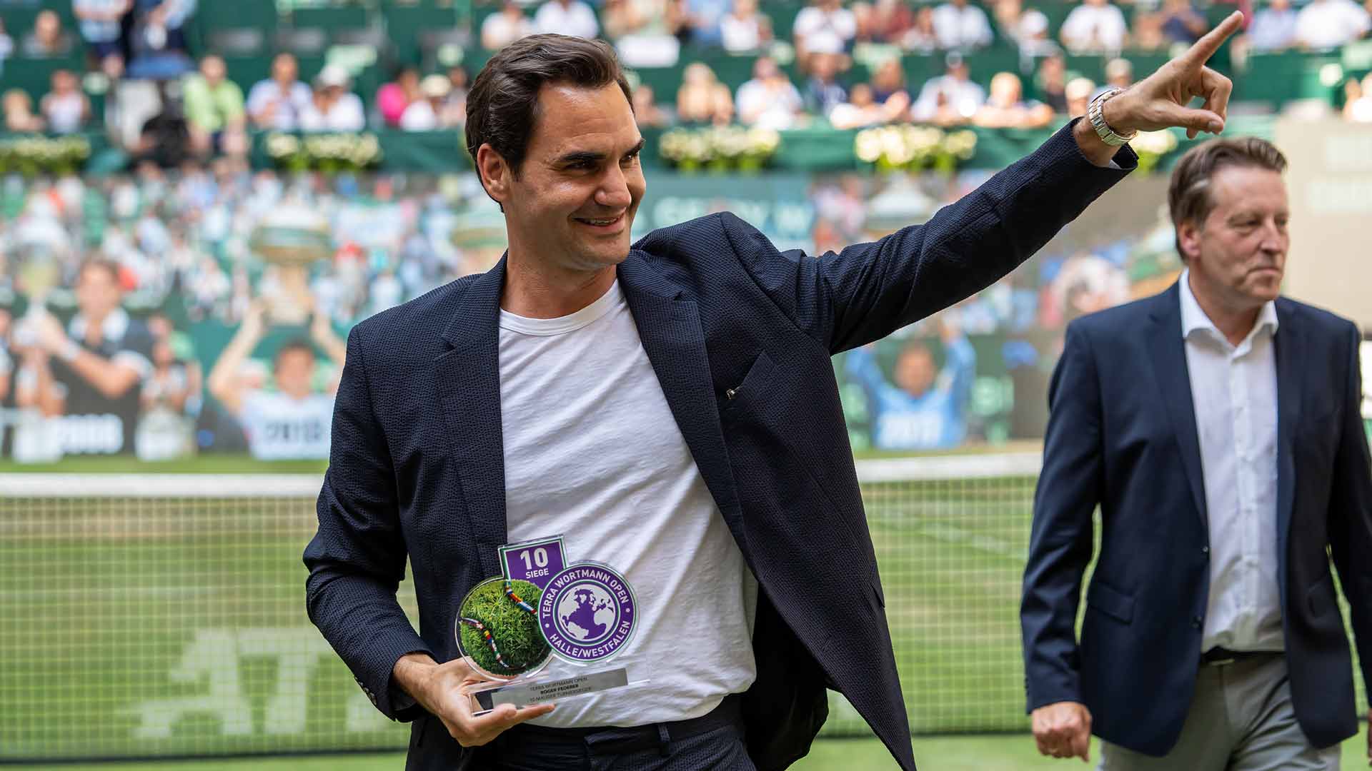 The 10-time champion Roger Federer is presented with an award by tournament director Ralf Weber on Wednesday in Halle.