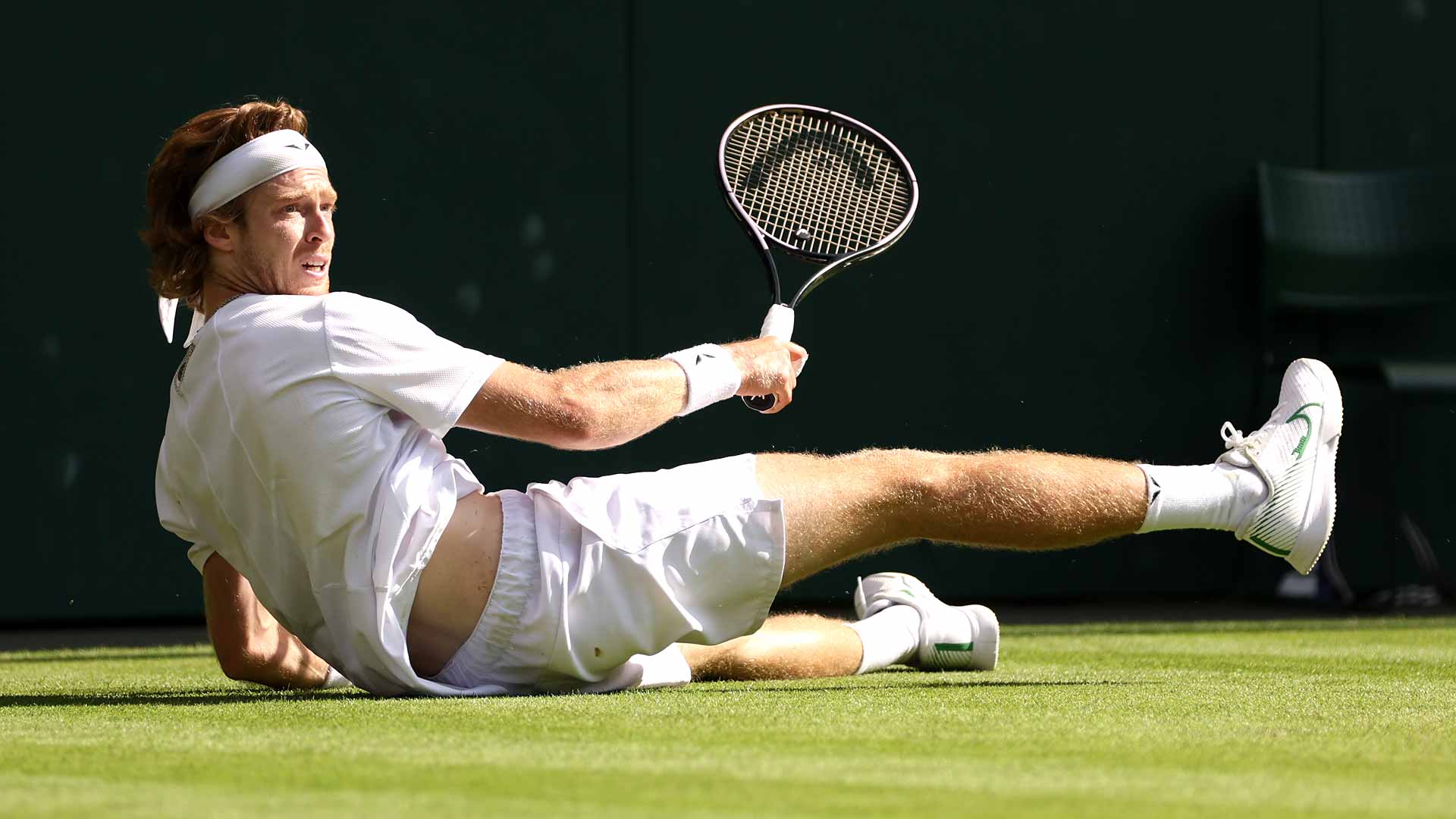 Andrey Rublev dives for a shot against Alexander Bublik as he serves for the match in the fourth round at Wimbledon on Sunday.