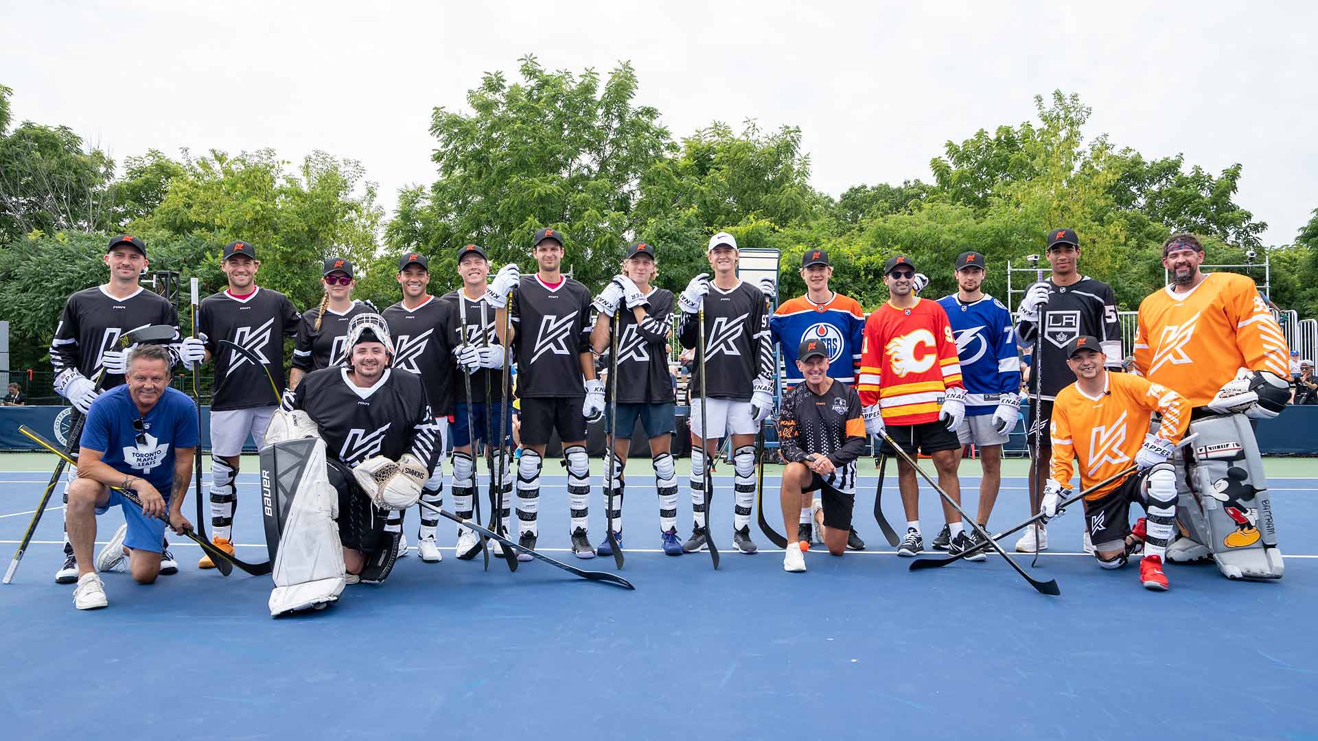 ATP and NHL stars pose for a group photo at the National Bank Open Presented by Rogers' annual ball hockey game.