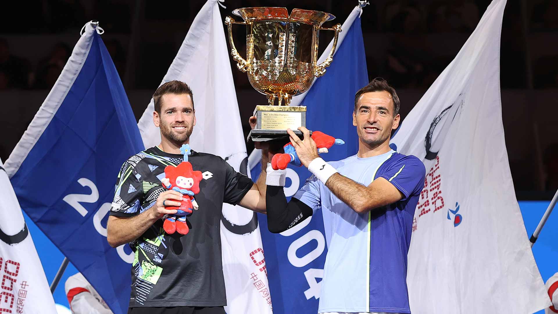 Austin Krajicek and Ivan Dodig lift the trophy in Beijing on Wednesday.