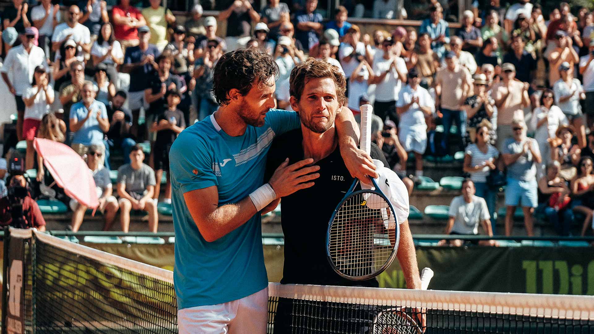 Joao Sousa (left) embraces Pedro Sousa, who was playing his final match Thursday in Lisbon.