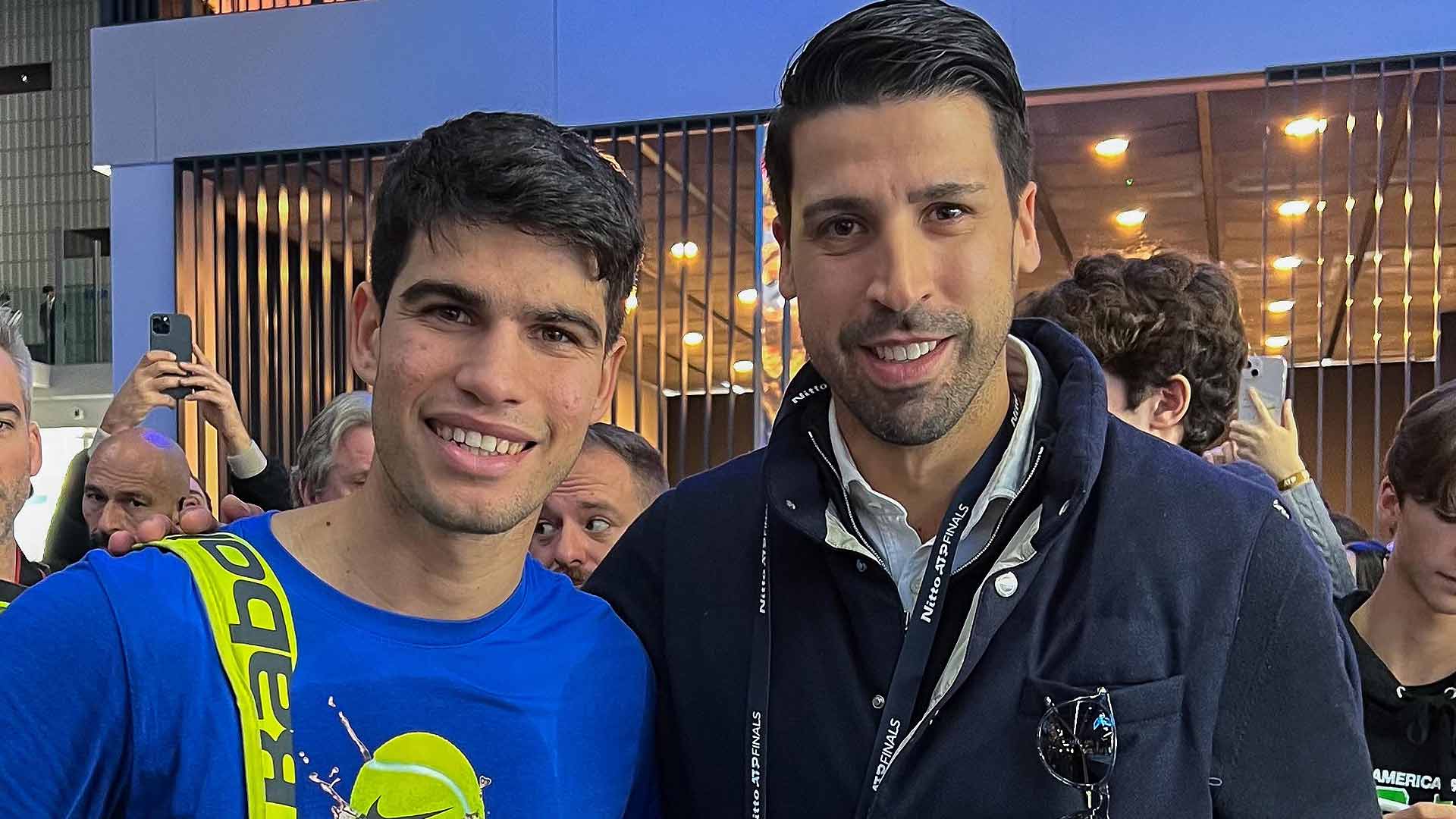 Carlos Alcaraz and Sami Khedira pose for a photo next to the practice court at the Pala Alpitour.