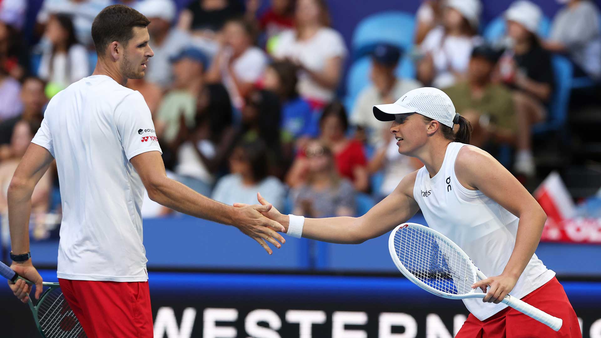 Hubert Hurkacz and Iga Swiatek in action in Perth on Monday.