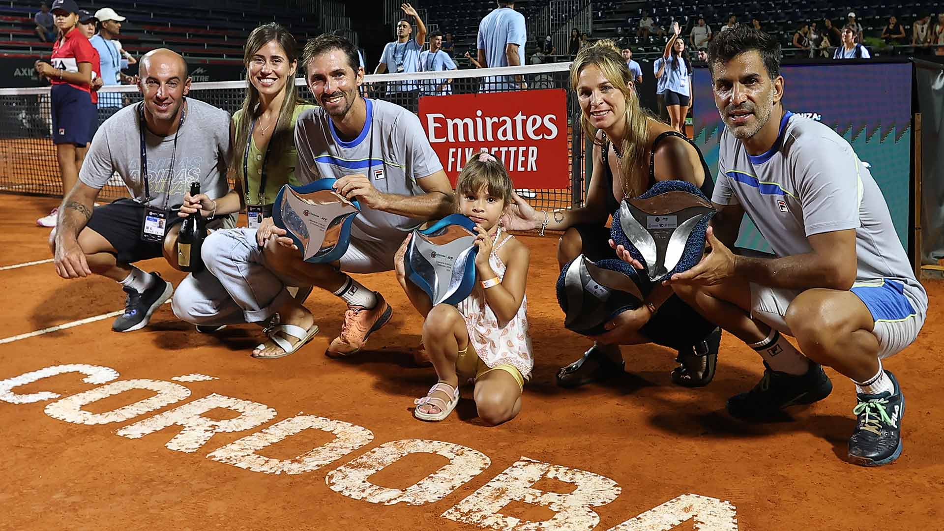 <a href='https://www.atptour.com/en/players/andres-molteni/me56/overview'>Andres Molteni</a> and <a href='https://www.atptour.com/en/players/maximo-gonzalez/g585/overview'>Maximo Gonzalez</a> celebrate their successful <a href='https://www.atptour.com/en/scores/archive/cordoba/9158/2024/results'>Cordoba Open</a> title defense with family and team.