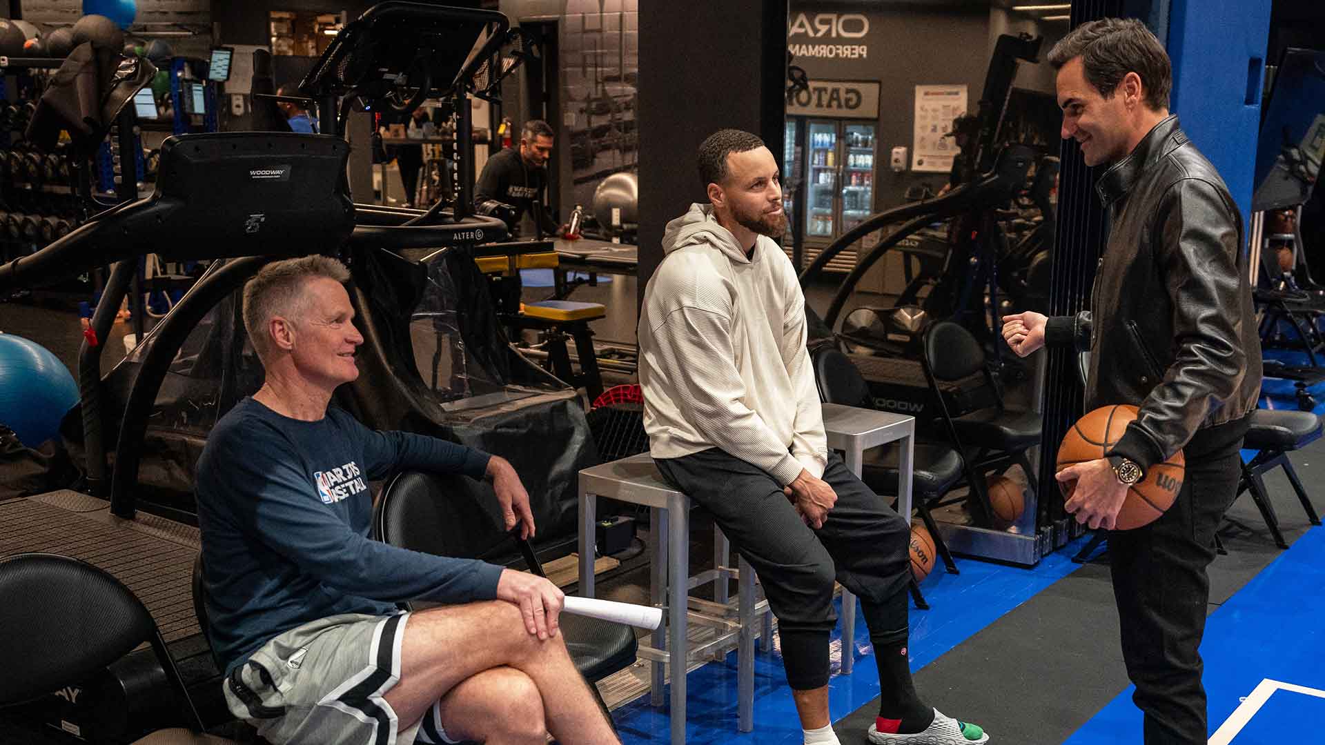 Steve Kerr, Steph Curry and Roger Federer catch up at The Chase Center on Saturday.