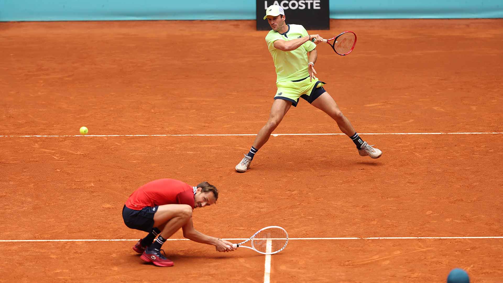 Duck and cover: Daniil Medvedev takes evasive action as Tommy Paul lets rip on Day 1 of doubles play in Madrid.