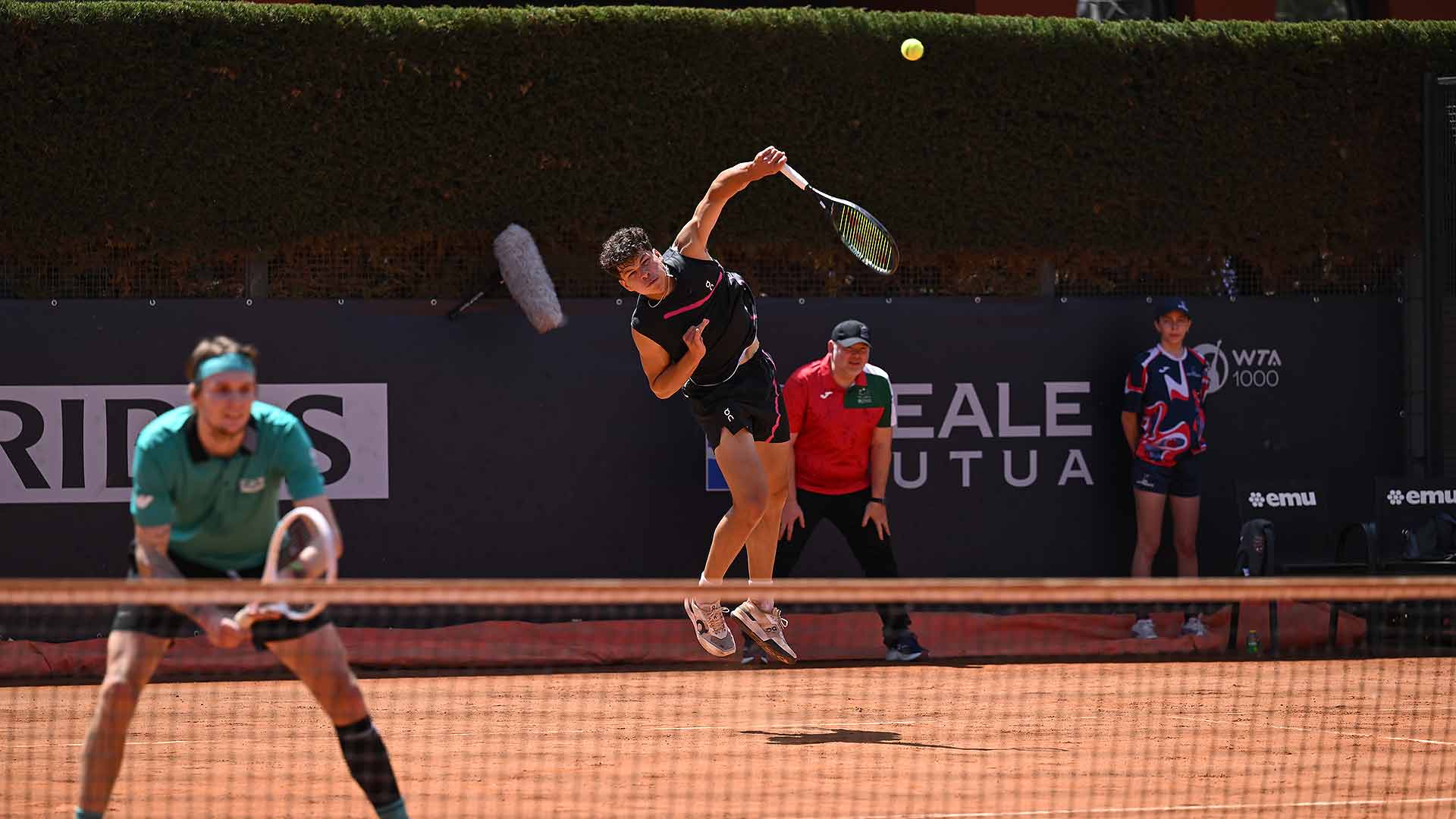 Ben Shelton (serving) and Alexander Bublik claim a tight first-round doubles win in Rome Thursday.