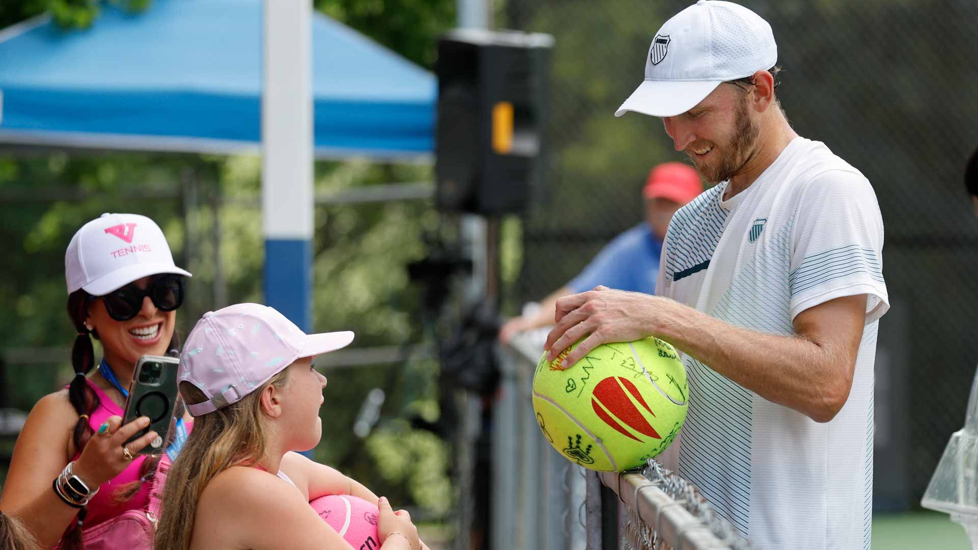<a href='https://www.atptour.com/en/players/mitchell-krueger/kc12/overview'>Mitchell Krueger</a> greets a young fan at the Little Rock Challenger.