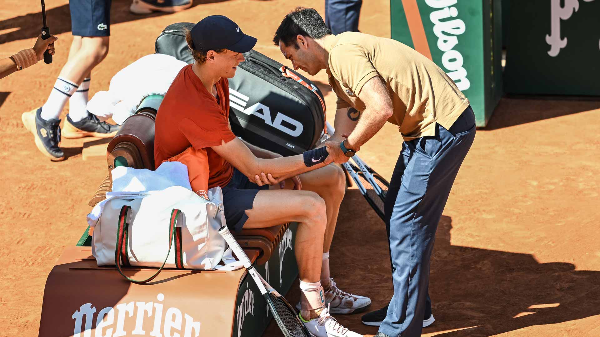Jannik Sinner receives treatment during his Roland Garros semi-final against Carlos Alcaraz.