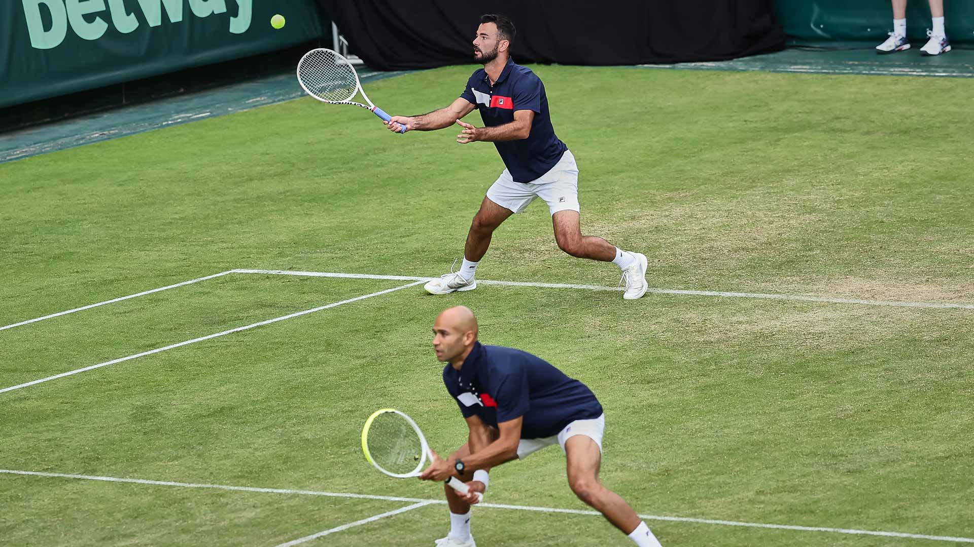 Sadio Doumbia (at net) and Fabien Reboul win a Match Tie-break Thursday to advance in Halle.