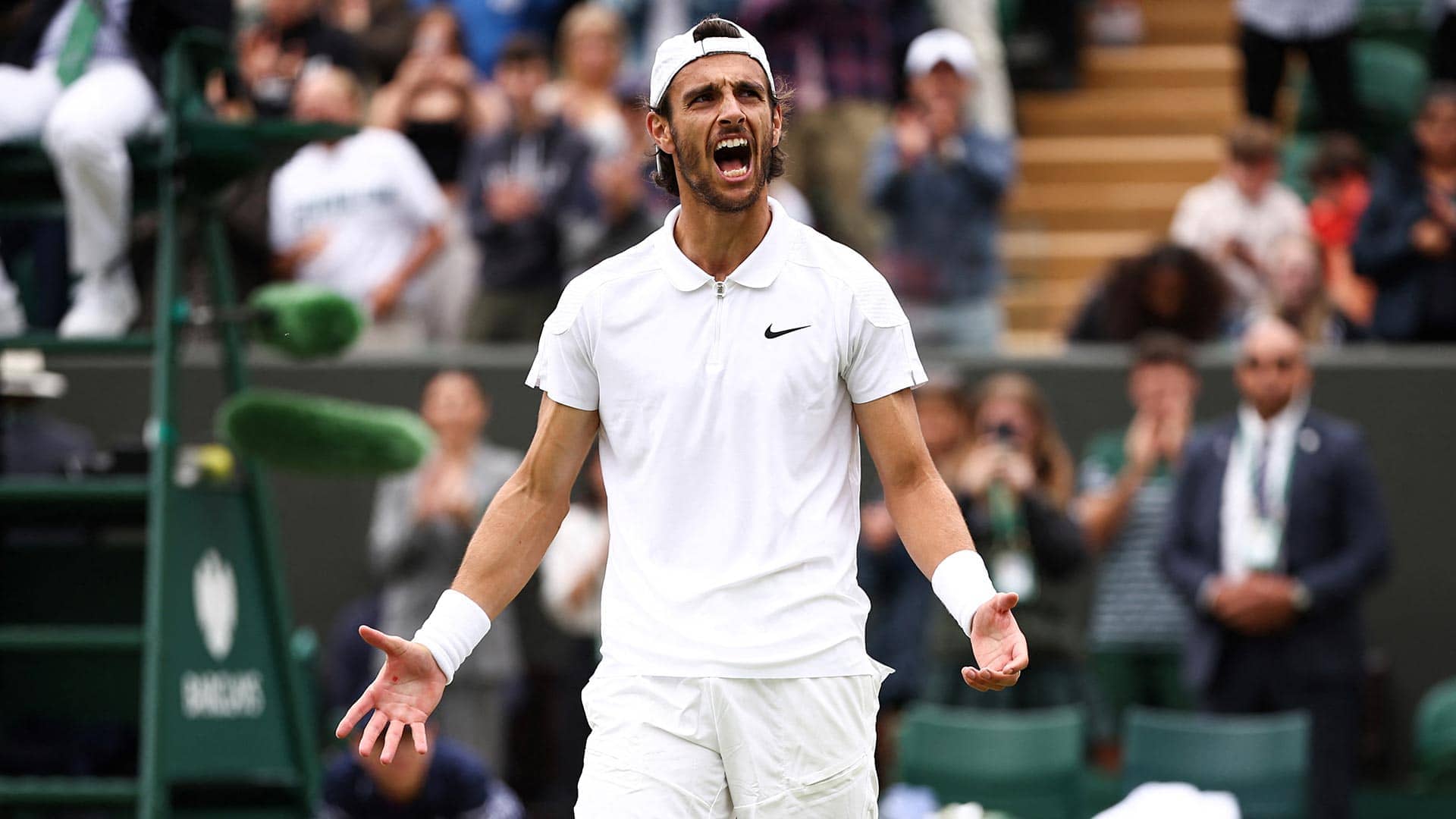 Lorenzo Musetti celebrates his victory at Wimbledon on Monday.