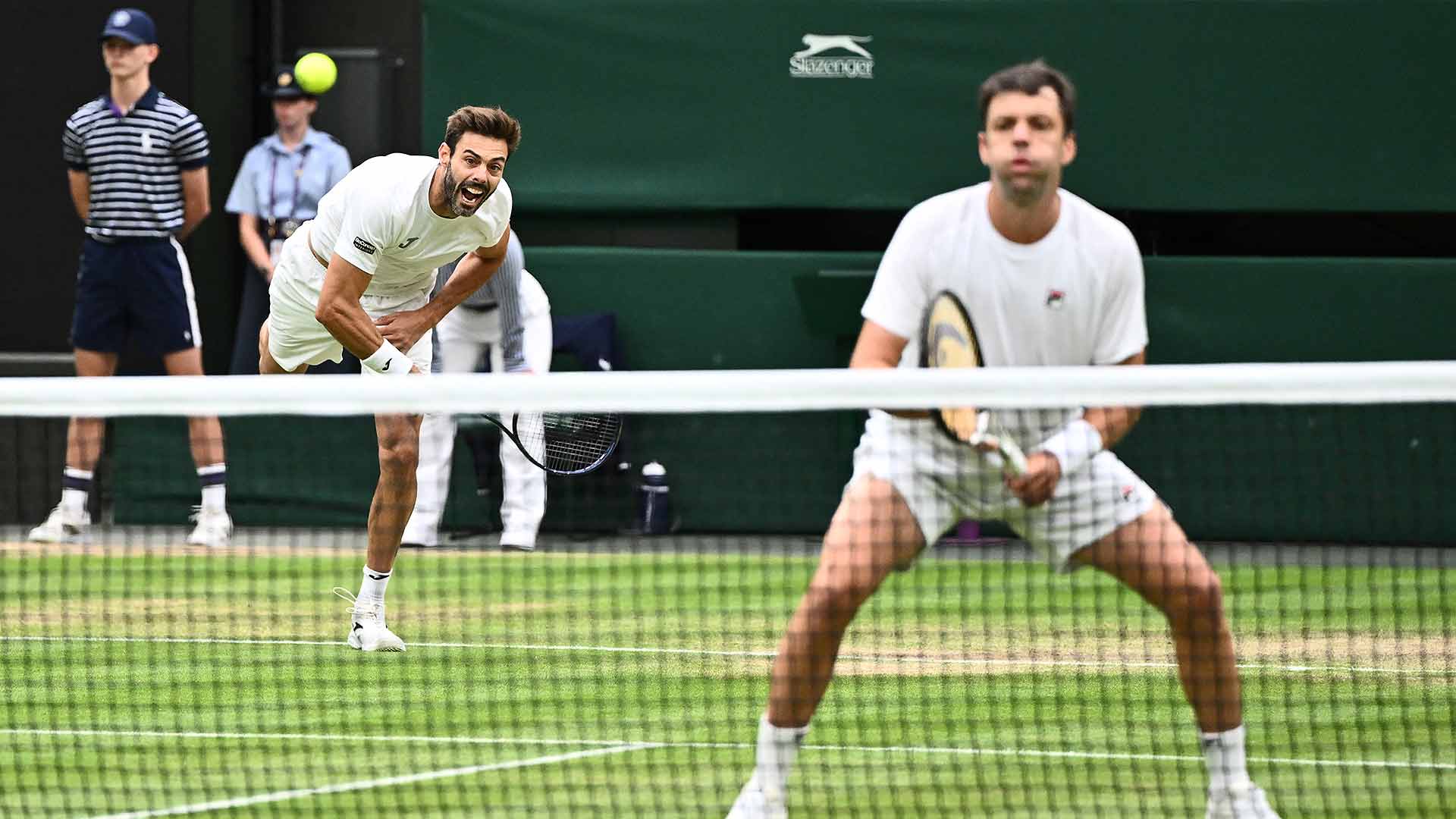 Marcel Granollers (serving) and Horacio Zeballos drop just six games in their third-round victory Monday. (file photo)