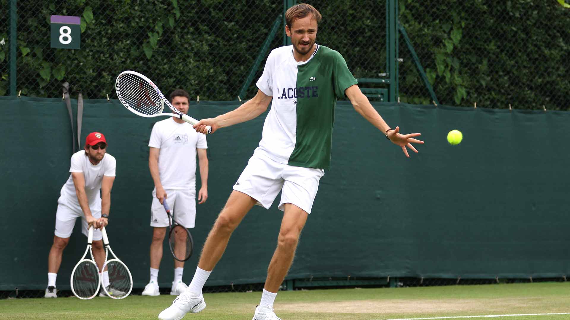 Gilles Cervara and Gilles Simon watch on as Daniil Medvedev practises at Wimbledon.