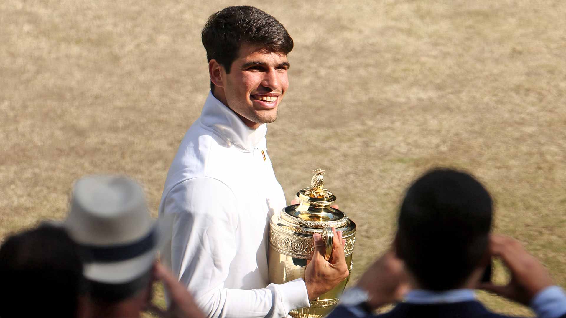 Carlos Alcaraz celebrates after capturing his fourth major title on Sunday at Wimbledon.
