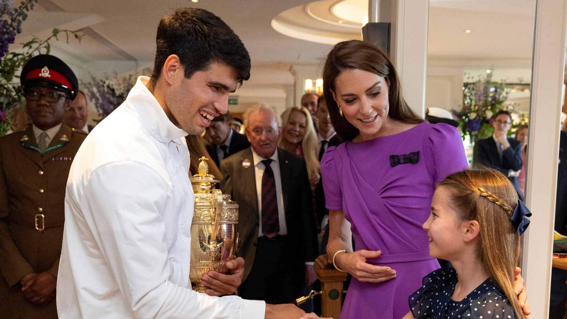 Carlos Alcaraz greets Kate Middleton, Princess of Wales, and Princess Charlotte after winning the Wimbledon title.