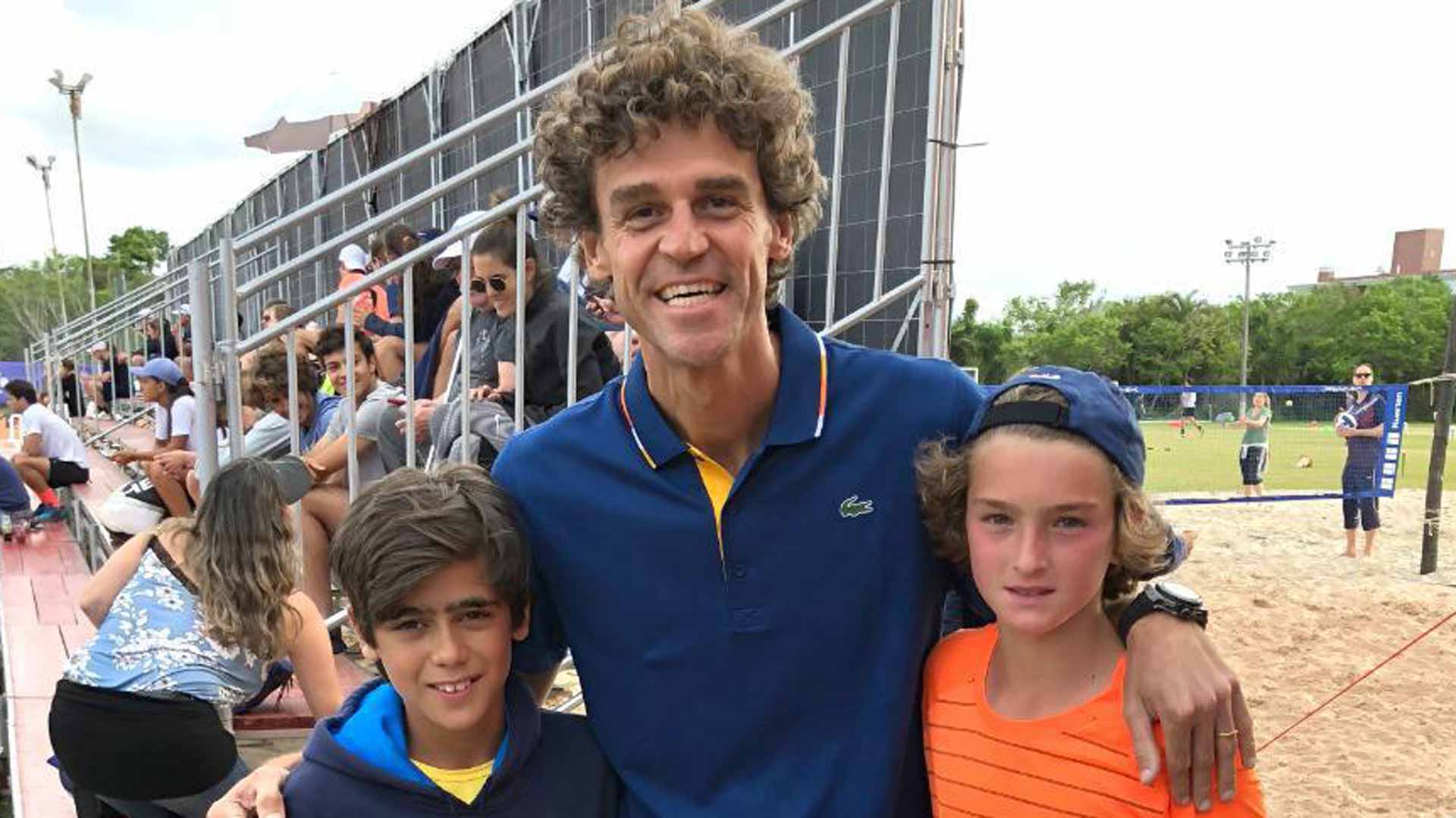 Joao Fonseca (far right) and a friend meet Gustavo Kuerten.