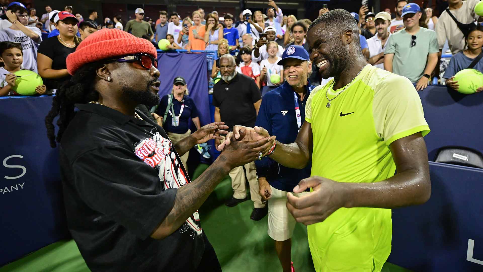 Wale and Frances Tiafoe chat after a match at this year's Mubadala Citi DC Open.