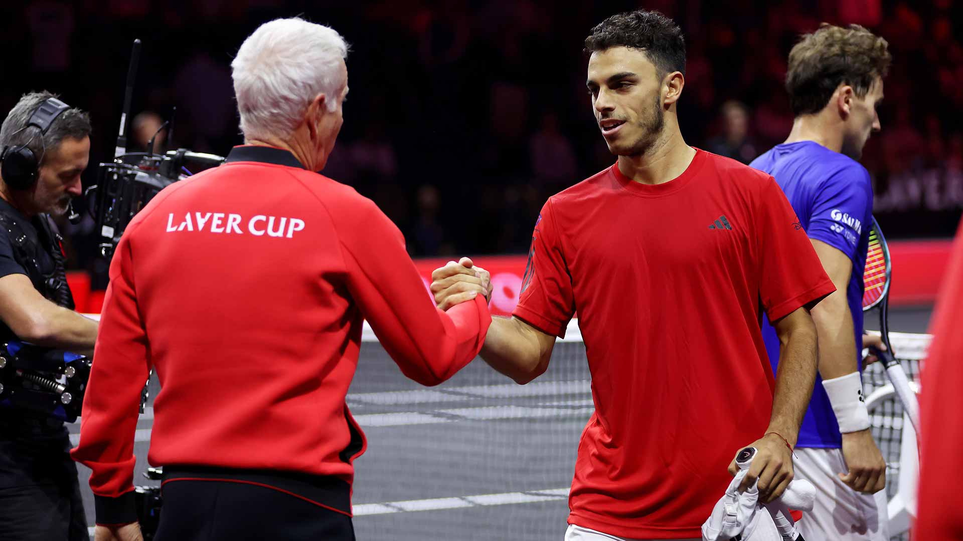 John McEnroe embraces Francisco Cerundolo after the Argentine defeats Casper Ruud in Berlin.