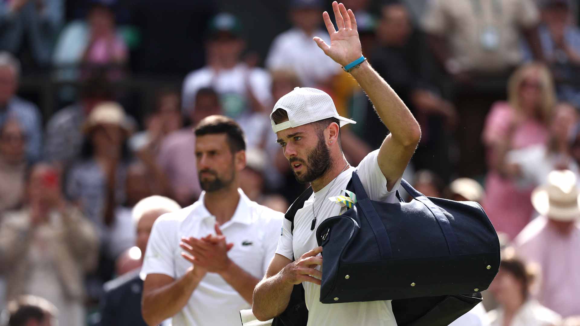 Novak Djokovic applauds Jacob Fearnley as the Briton leaves Centre Court at Wimbledon.