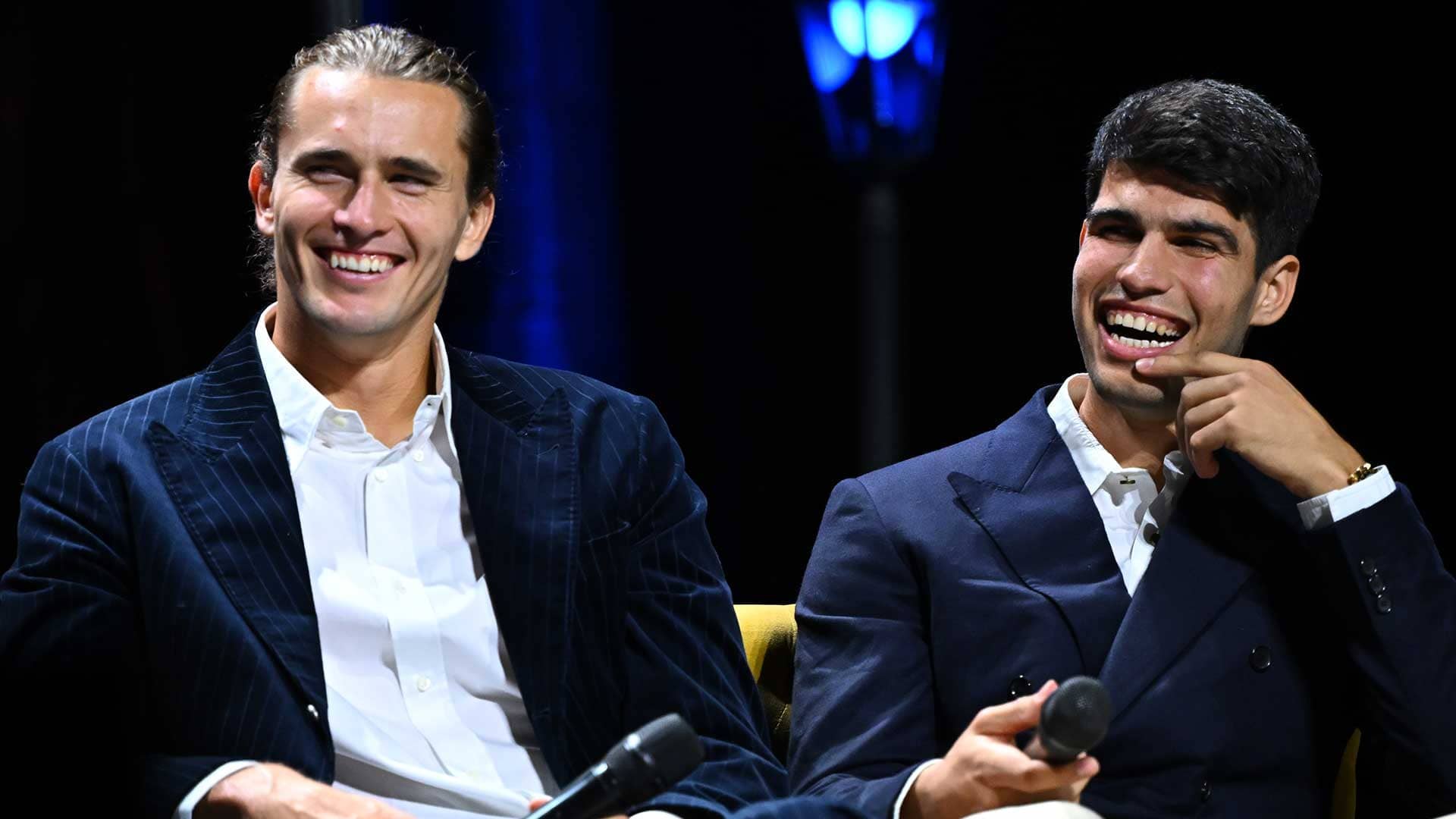 Alexander Zverev and Carlos Alcaraz share a joke on stage in Turin.