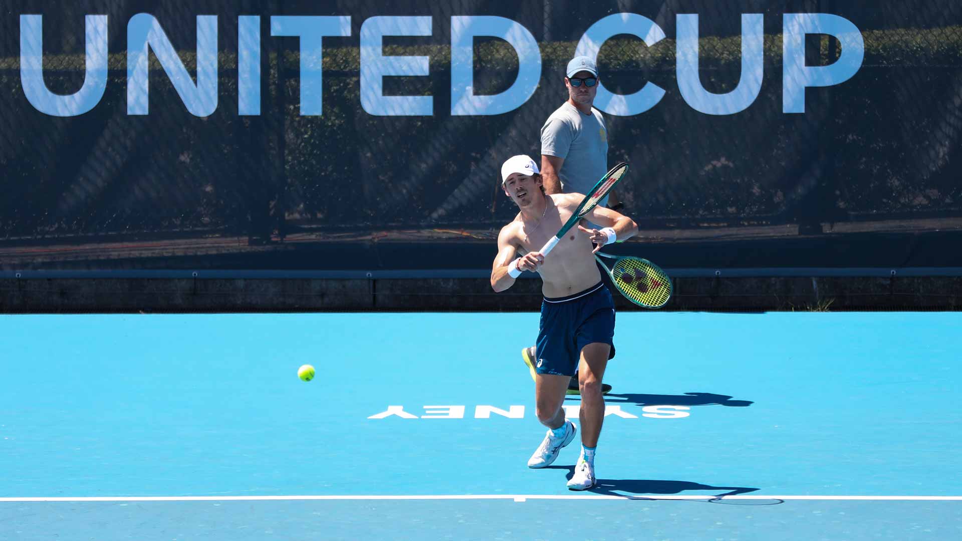 Alex de Minaur practises under the watchful eye of Lleyton Hewitt on Thursday in Sydney.