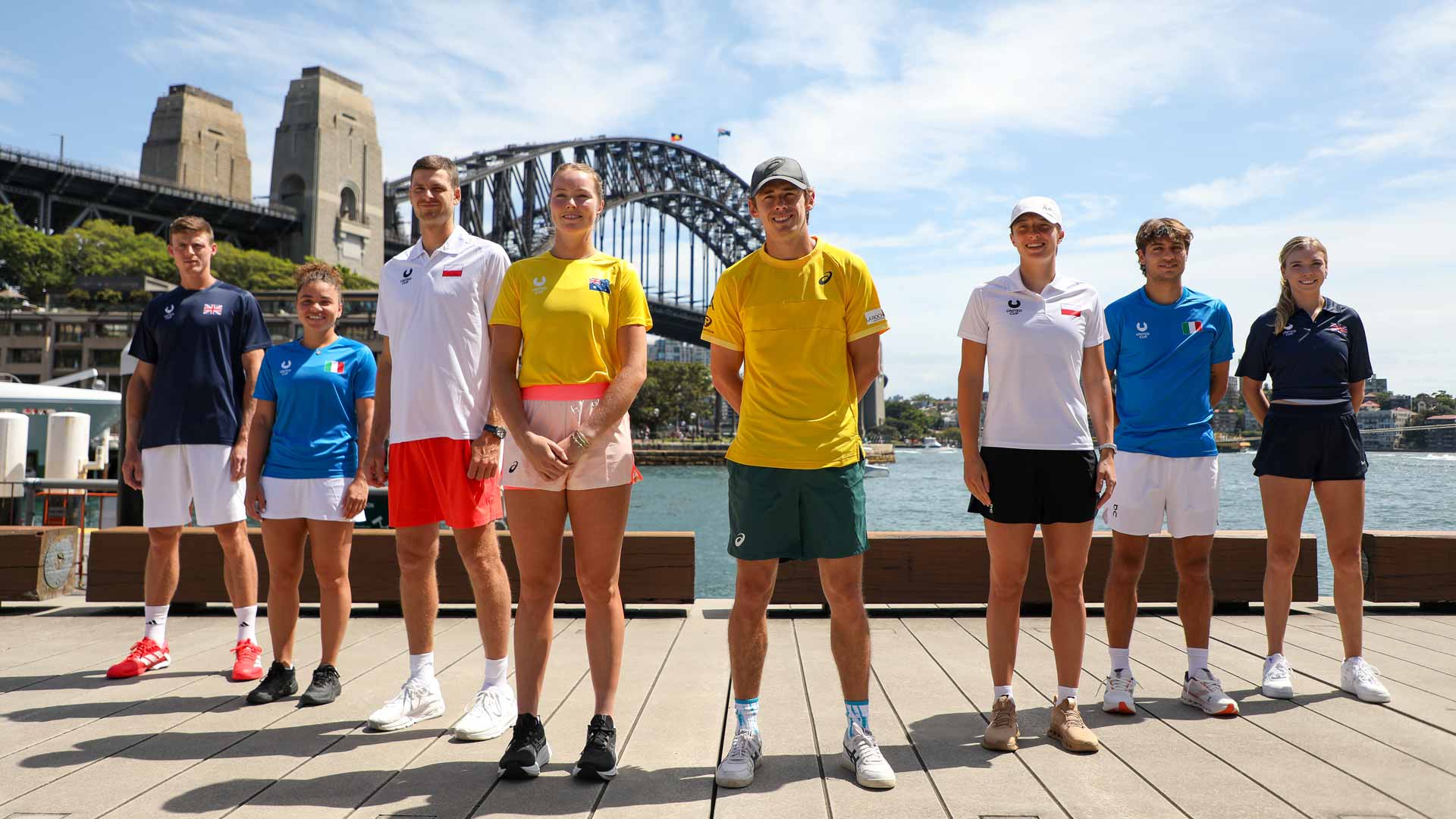 Members of Teams Australia, Poland, Italy and Great Britain pose in front of Sydney Harbour Bridge on Friday ahead of the 2025 United Cup.