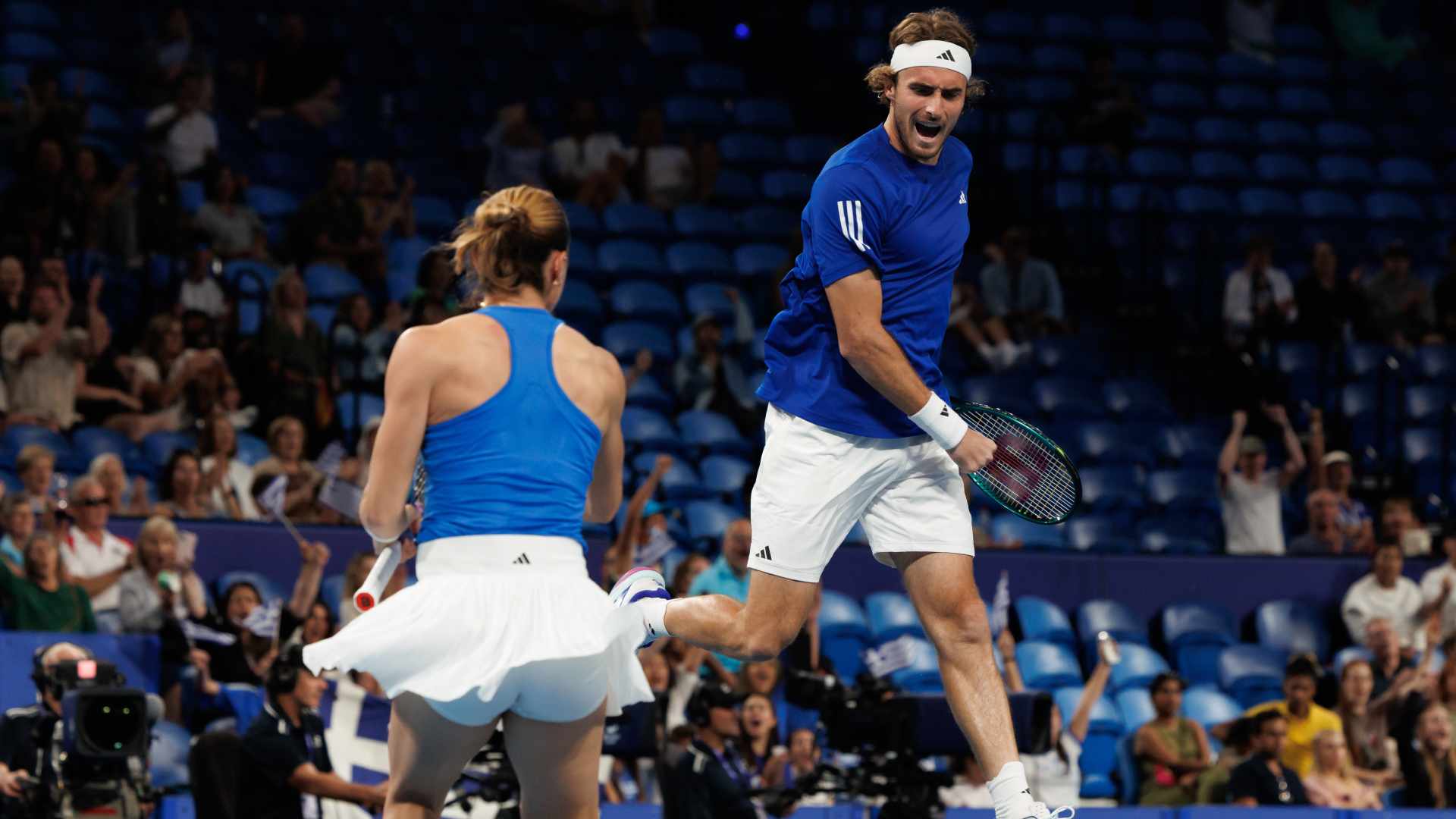 Stefanos Tsitsipas and Maria Sakkari celebrate after defeating Spain at the United Cup in Perth.