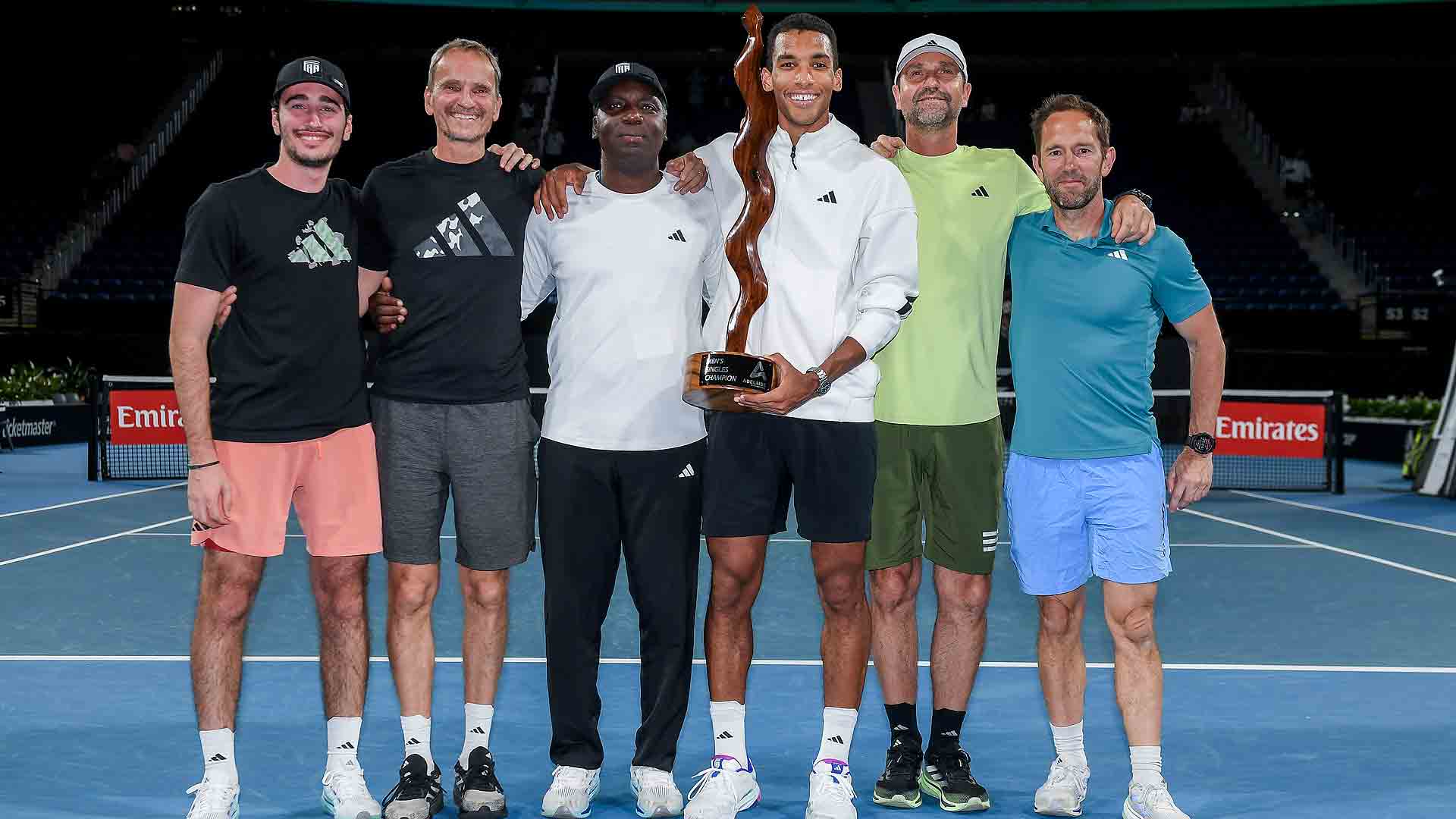 Felix Auger-Aliassime celebrates his Adelaide triumph with his team on Saturday.
