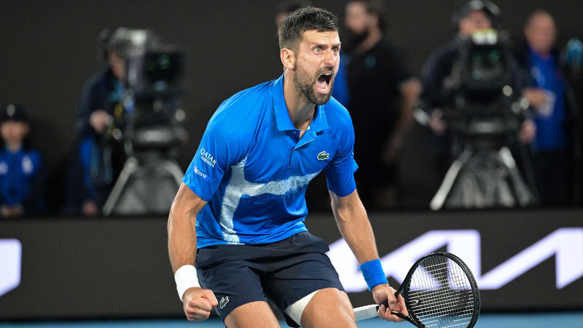 Novak Djokovic celebrates reaching a record-extending 50th major semi-final.
