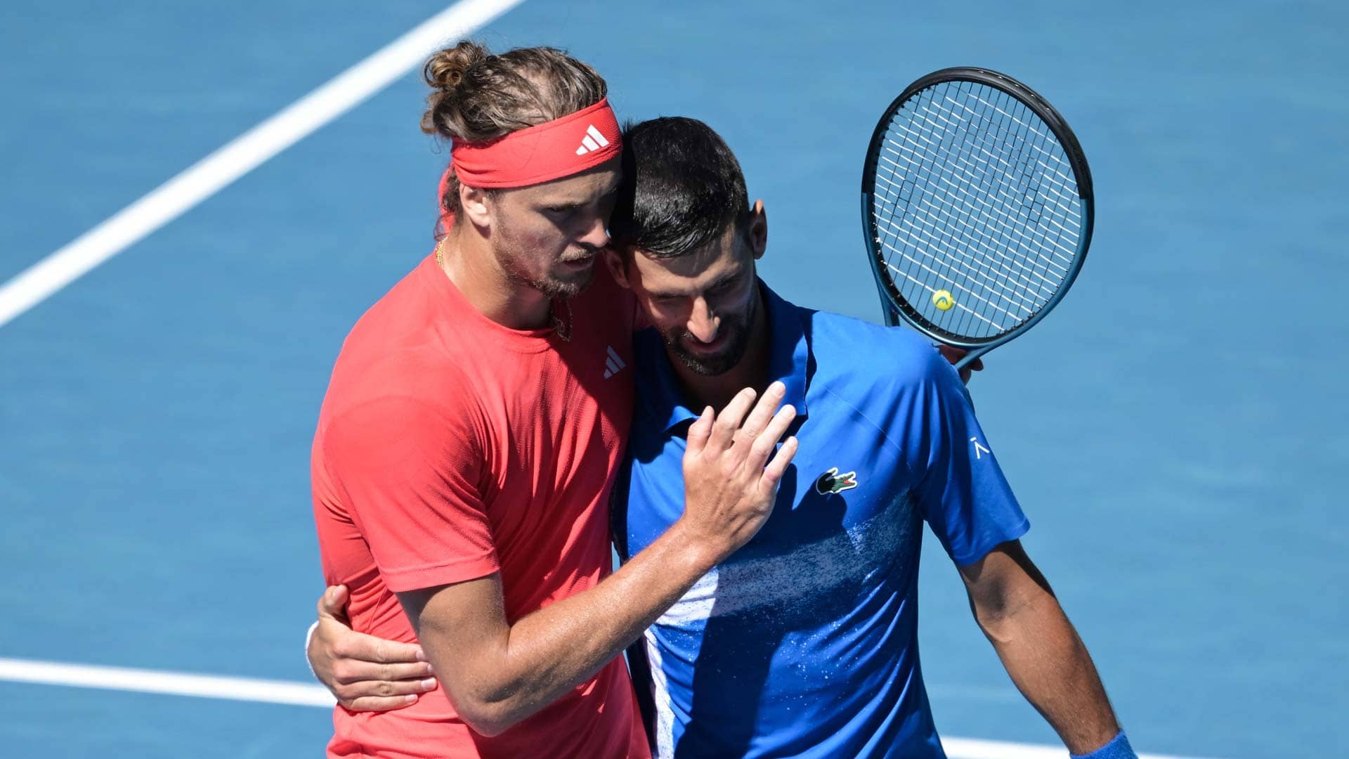 Alexander Zverev and Novak Djokovic embrace after the Serbian retires from their Australian Open semi-final on Friday.