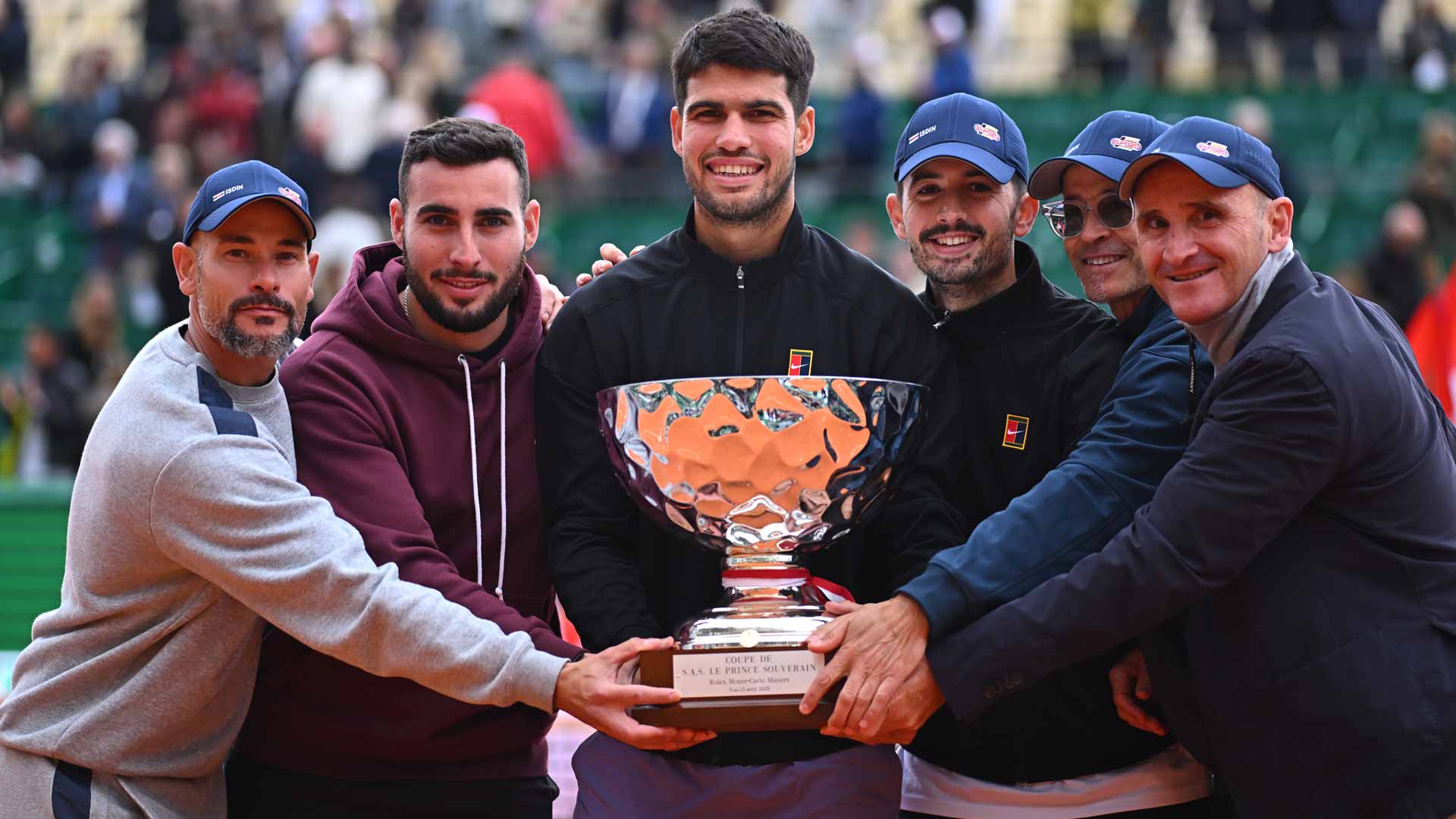 Carlos Alcaraz celebrates his first Monte-Carlo trophy with his team Sunday.
