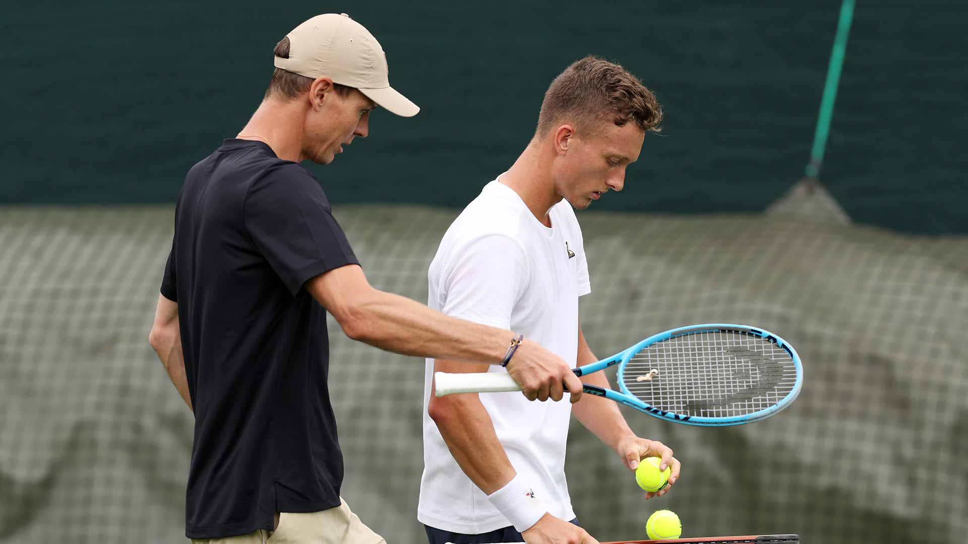 Tomas Berdych mentors Jiri Lehecka at training Tuesday at Wimbledon.
