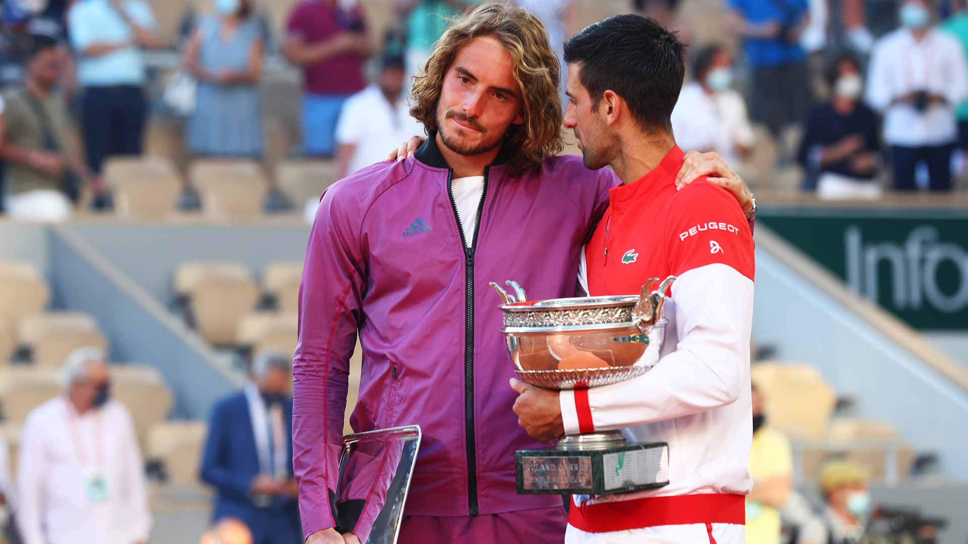 Stefanos Tsitsipas and Novak Djokovic embrace after a five-set thriller at Roland Garros in 2021.