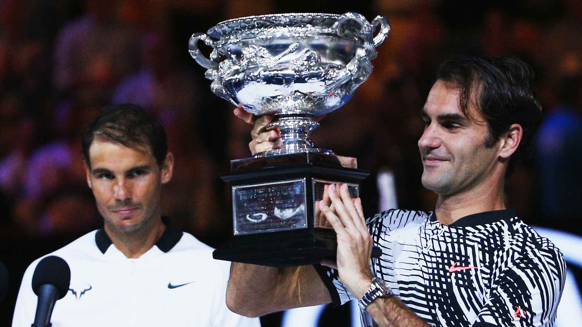 Roger Federer lists the 2017 Australian Open trophy after defeating Rafael Nadal in the final.