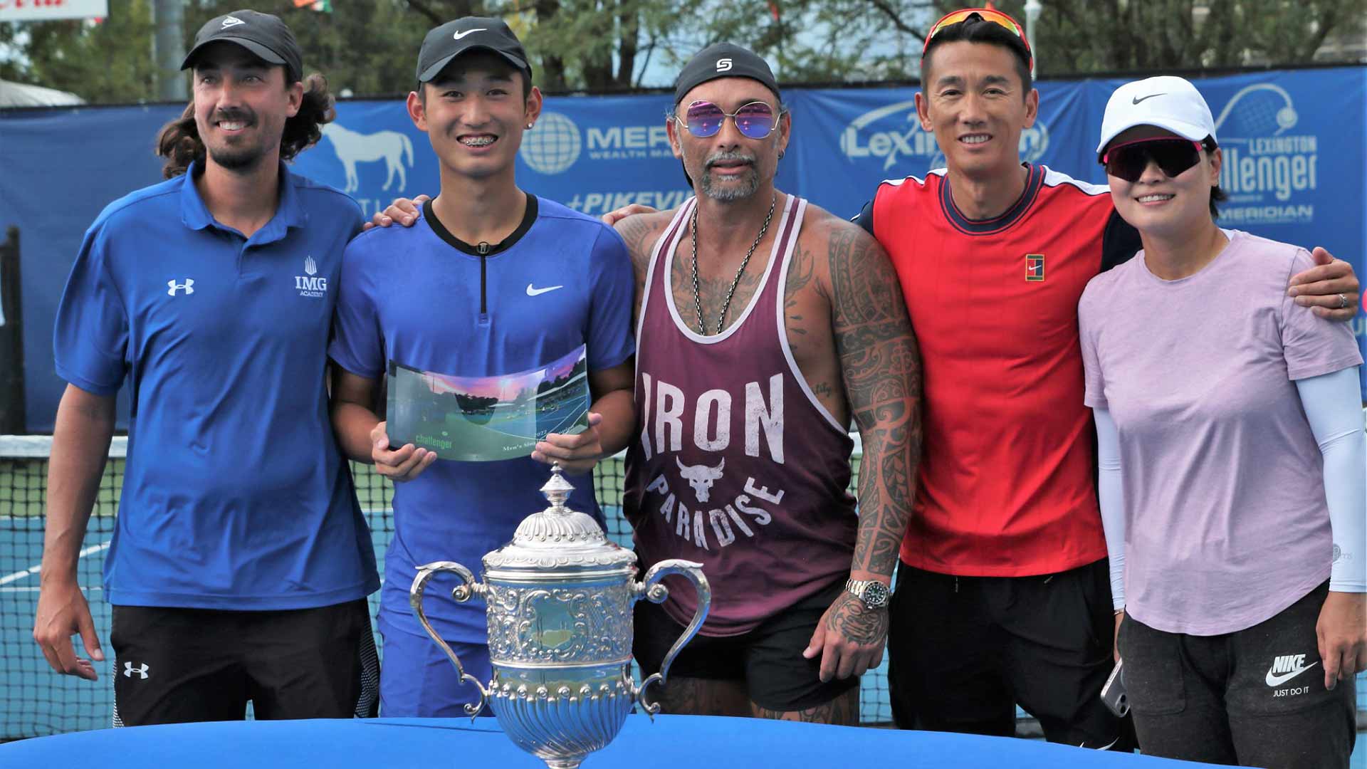 Shang Juncheng celebrates his Lexington Challenger title with coach Marcelo Rios.